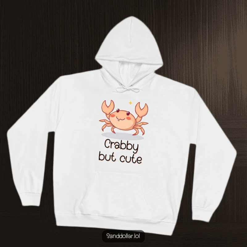 Funny Hoodie featuring a small crab character scuttling sideways with a sparkle of mischief in its eyes, offering warmth and humor.